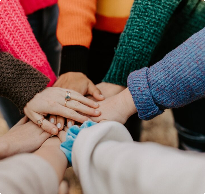 People joining hands in a circle